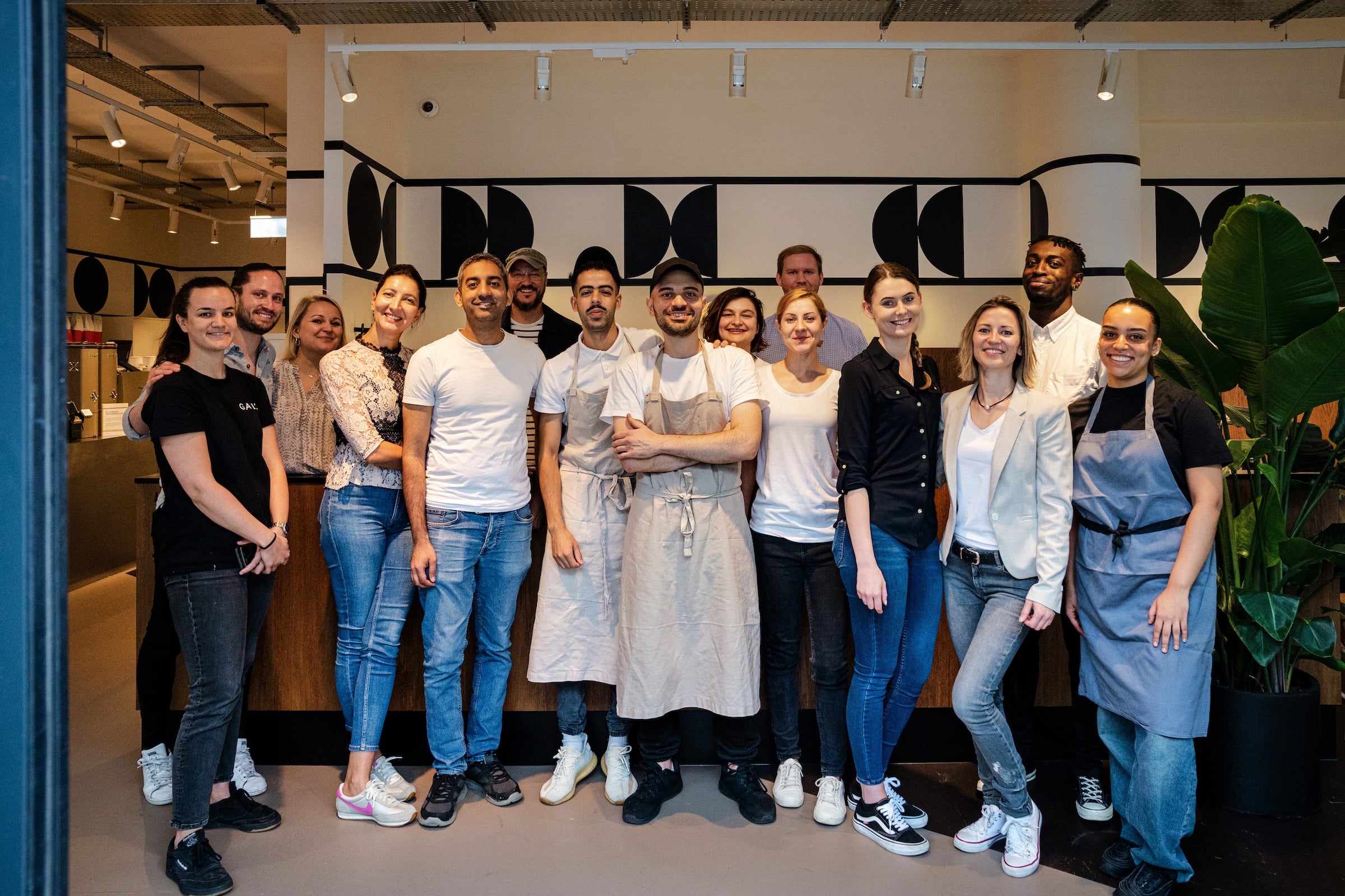 Group of restaurant staff posing together.
A group of restaurant staff smiling for a photo.