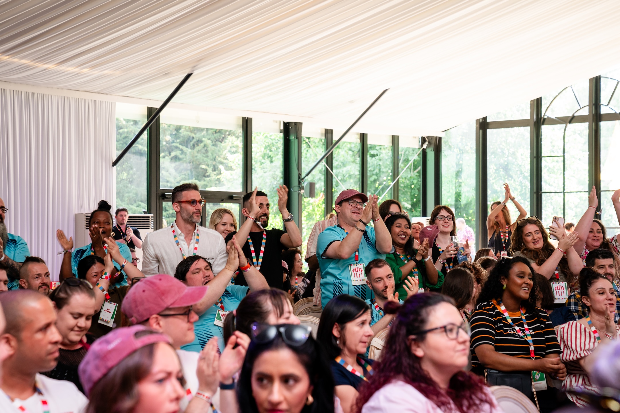People clapping, celebrating at an event.